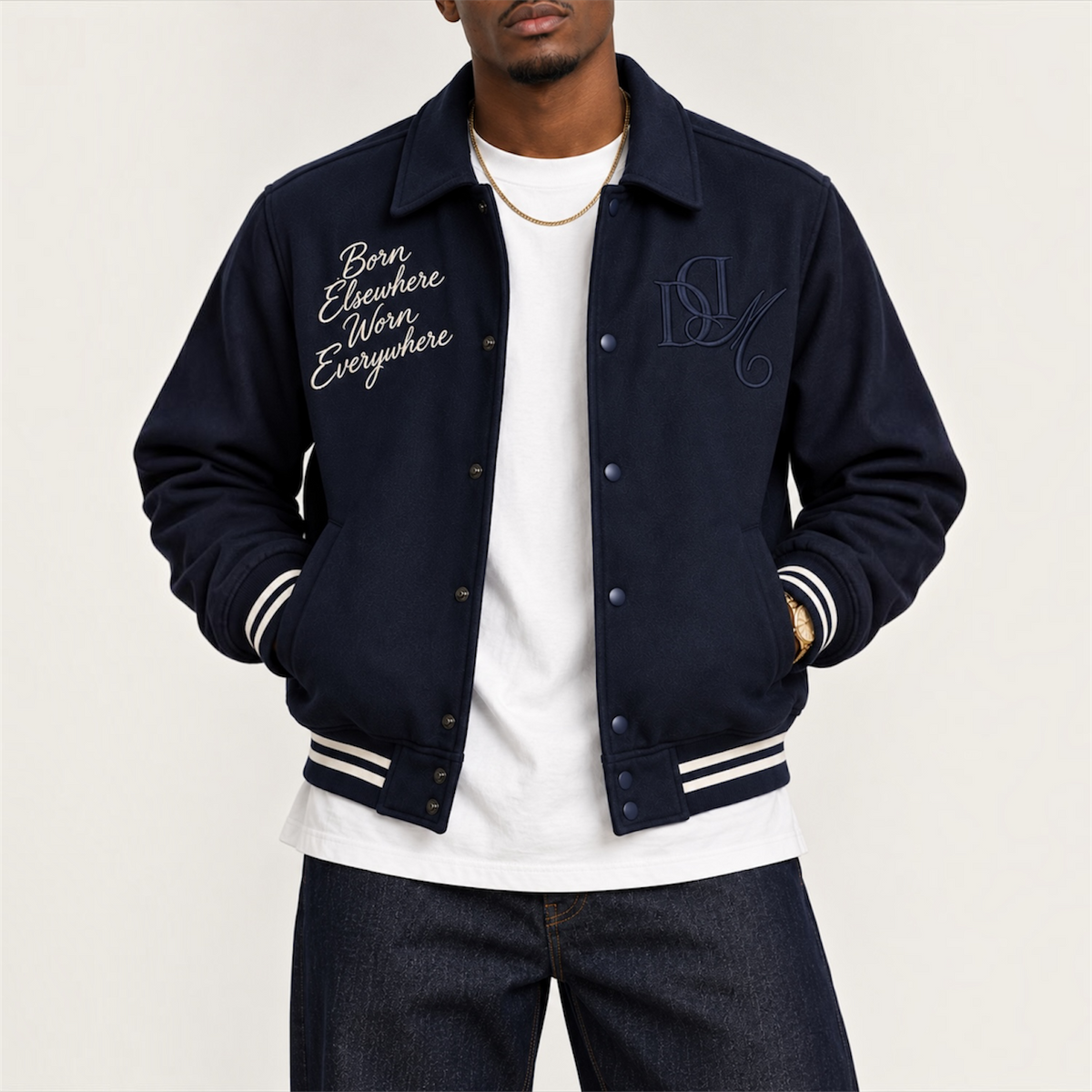 Close-up front embroidery and tonal monogram on DonDeMarco navy varsity wool jacket