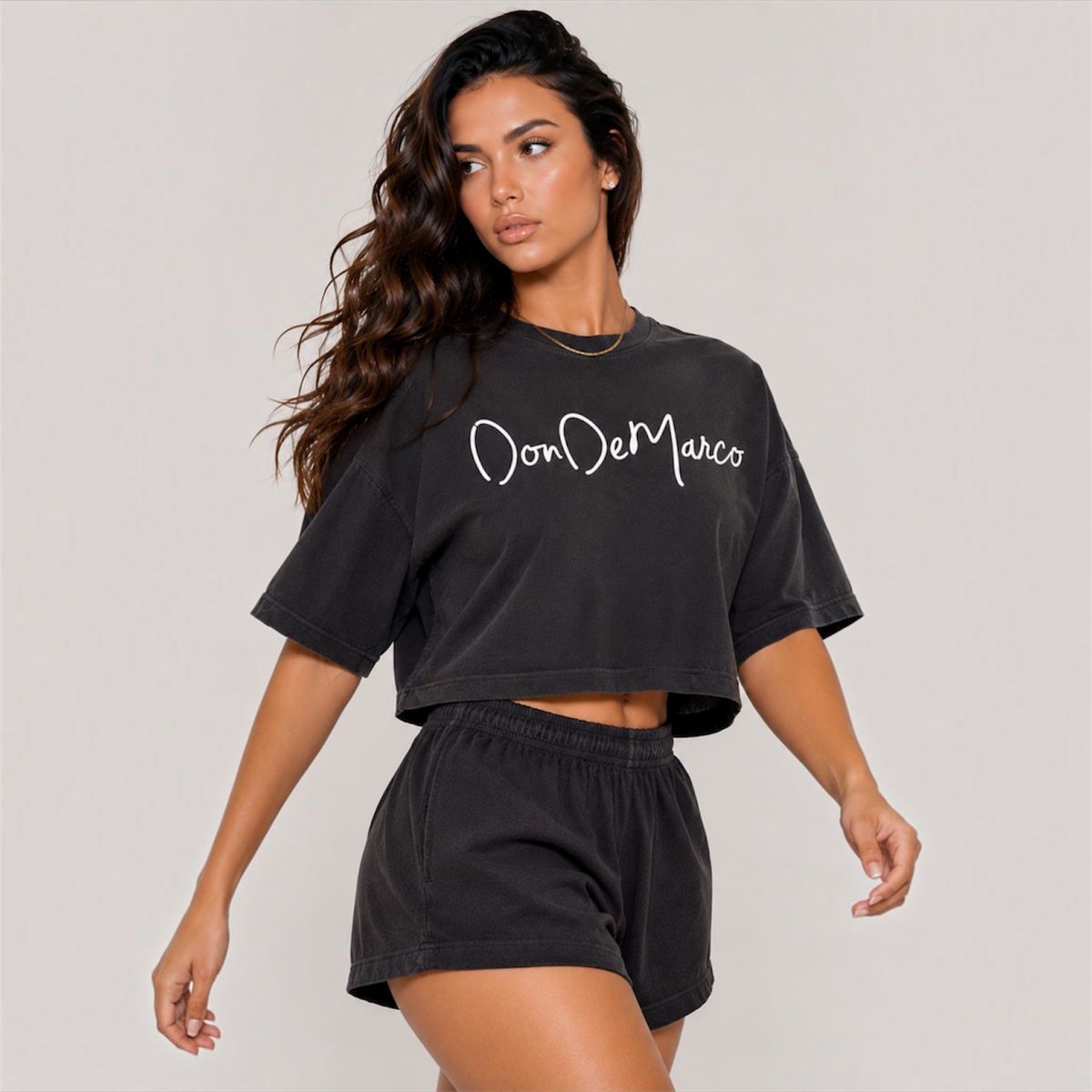 DonDeMarco women’s garment dye cropped tee and shorts set, washed black walking model view