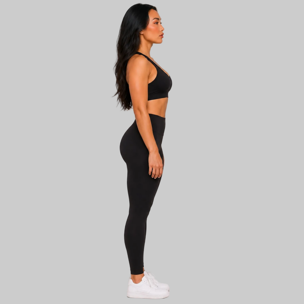 Model wearing DonDeMarco black high waist 7/8 active leggings, shown with matching bra top