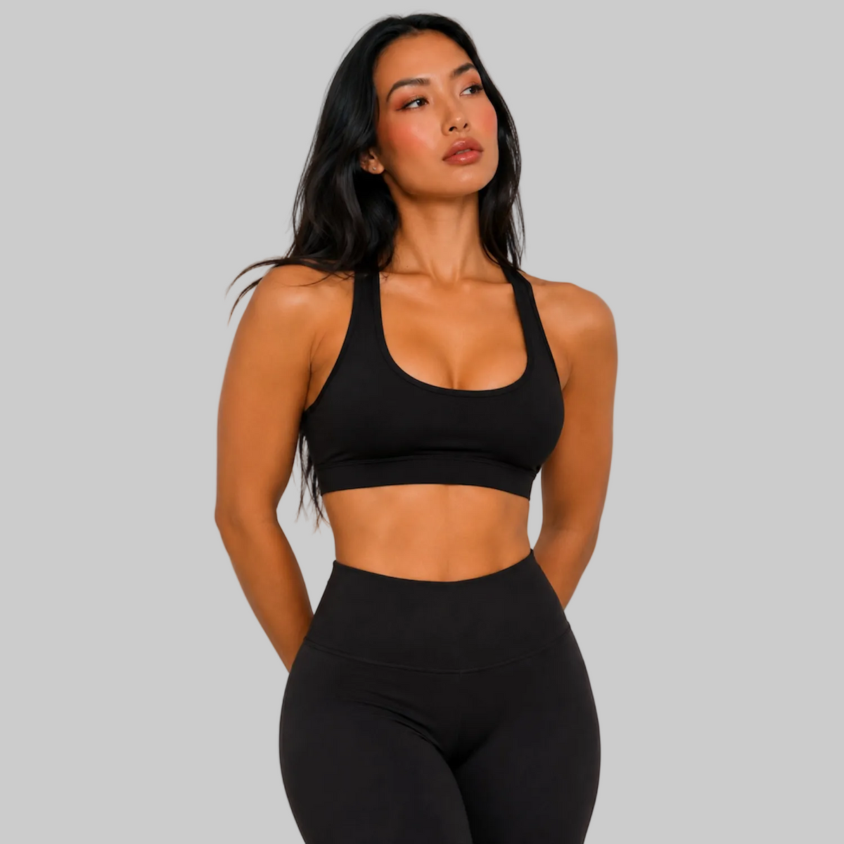 Model wearing DonDeMarco black high waist 7/8 active leggings, shown with matching bra top