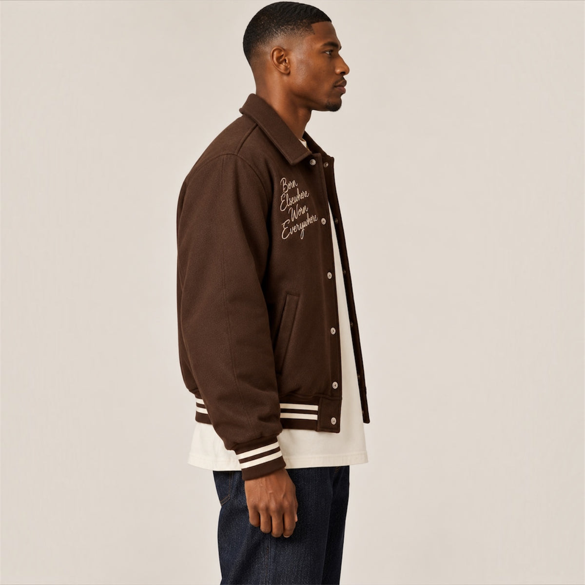 Side profile of DonDeMarco chocolate brown varsity wool jacket
